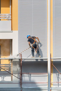 Low angle view of men working at construction building