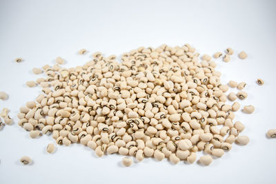 High angle view of roasted coffee beans on white background