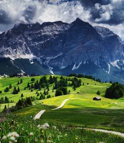 Scenic view of rocky mountains against cloudy sky