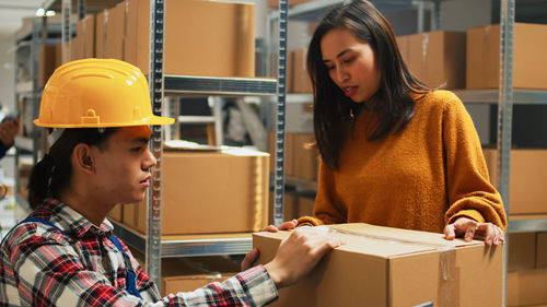 Portrait of young woman working in factory