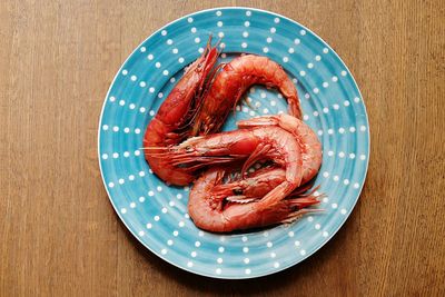 Directly above shot of red chili peppers in plate on table