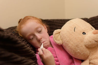 Close-up of cute girl relaxing on bed at home