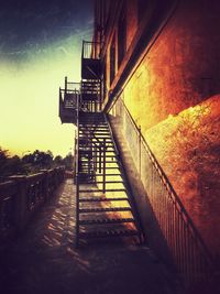 Staircase by building against sky