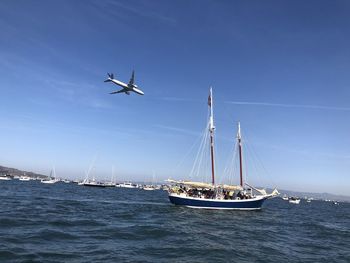 Sailboat sailing on sea against sky