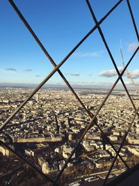 Cityscape seen through chainlink fence