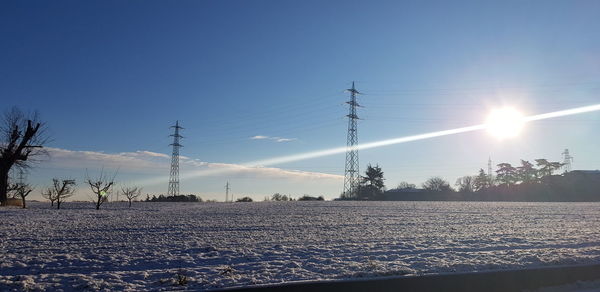 Scenic view of snow covered field against sky