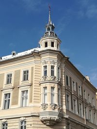 Low angle view of building against cloudy sky