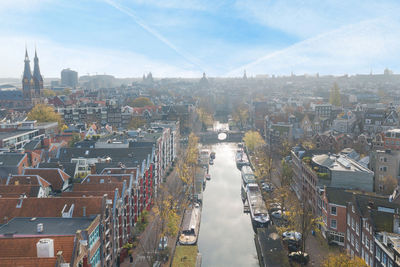 High angle view of buildings in town against sky