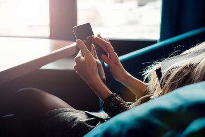 Midsection of woman using mobile phone