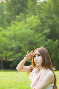 Woman sitting on field at park