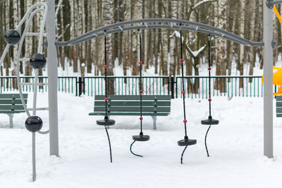 Empty swings in park during winter