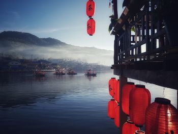 Red lanterns hanging over mountain against sky