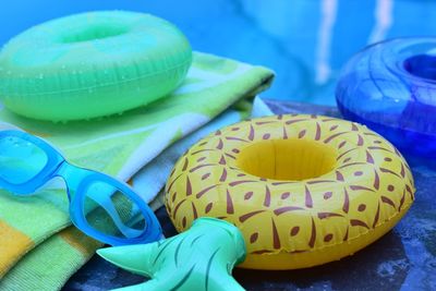 Close-up of swimming goggles and inflatable rings