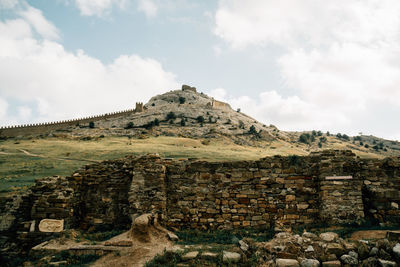 Scenic view old ruins on field against sky