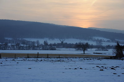 Scenic view of lake against sky during sunset