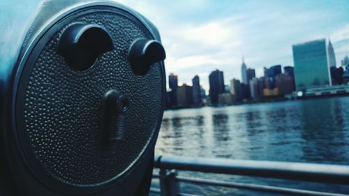 Close-up of coin-operated binoculars by east river