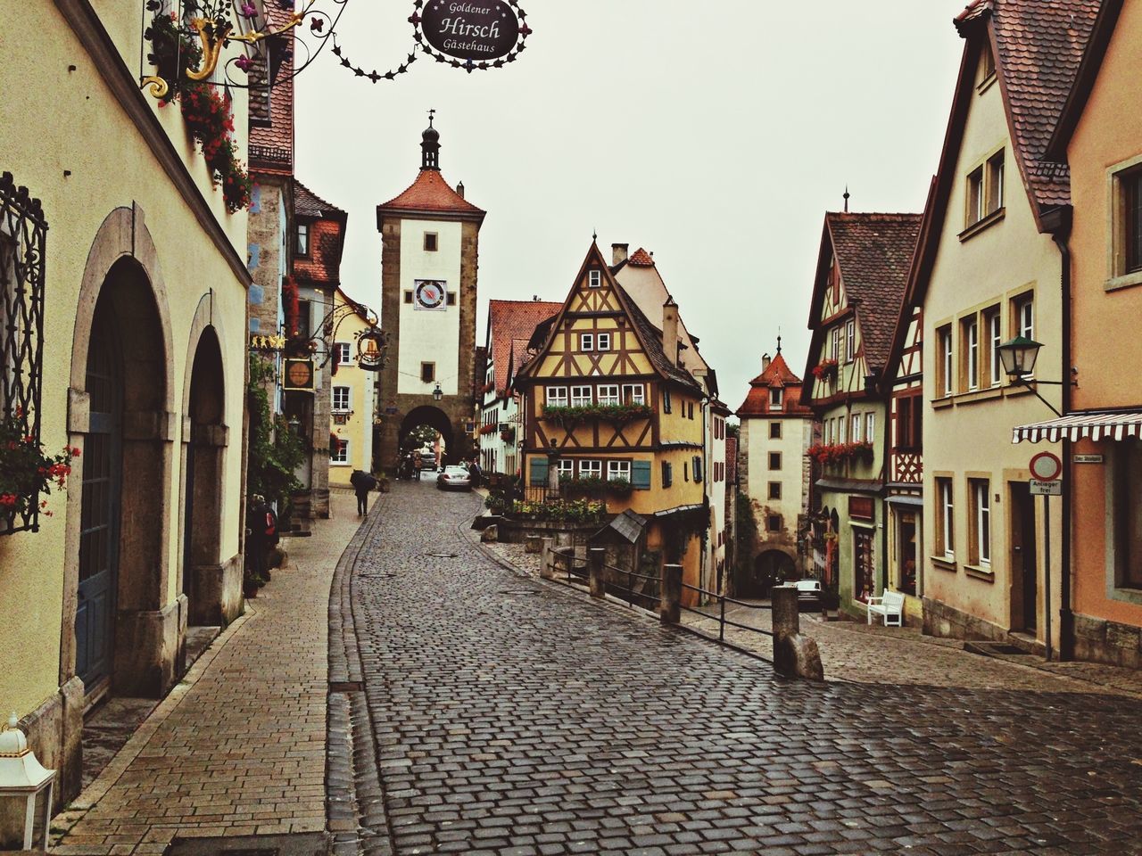 building exterior, architecture, built structure, cobblestone, street, the way forward, walking, city, residential building, men, residential structure, incidental people, person, building, footpath, lifestyles, city life, diminishing perspective