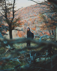 Full length of man standing by tree