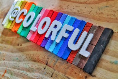 High angle view of text on colorful wood