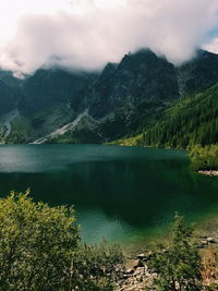 Scenic view of lake and mountains against sky