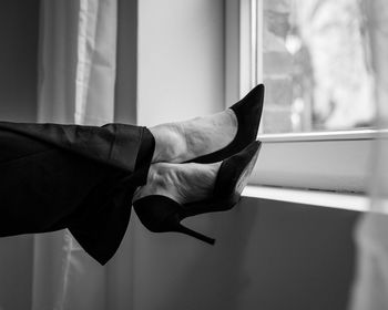 Feet in high heels on the windowsill