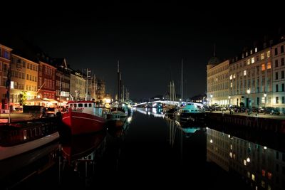 Boats in canal at night