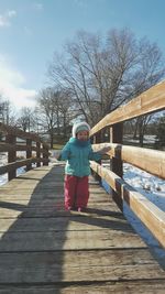 Woman walking on footbridge