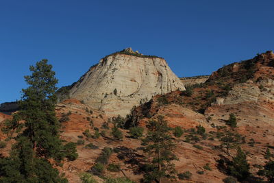 Low angle view of mountain against clear blue sky