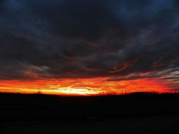 Silhouette of landscape against dramatic sky