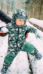 Boy in snow on field