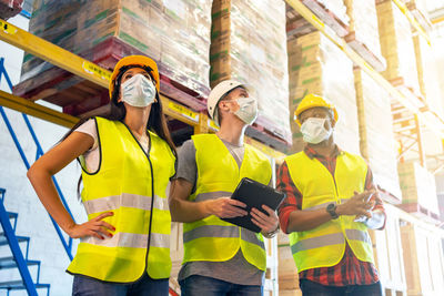 Colleagues wearing protective workwear while standing outdoors