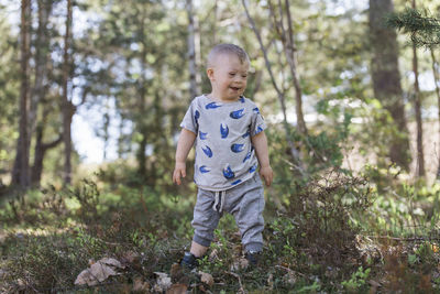 Cute boy standing in forest
