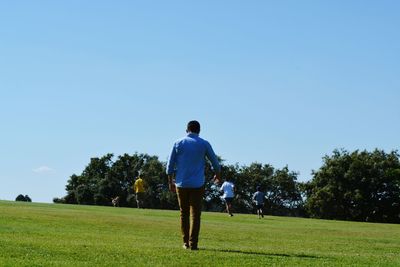 Full length of man standing on grassy field