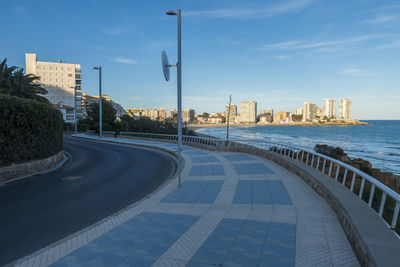 Street amidst buildings in city against sky