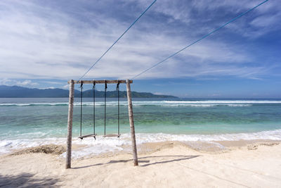 Lifeguard hut on beach against sky