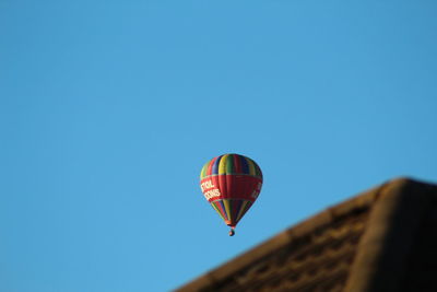 Low angle view of hot air balloon against clear blue sky