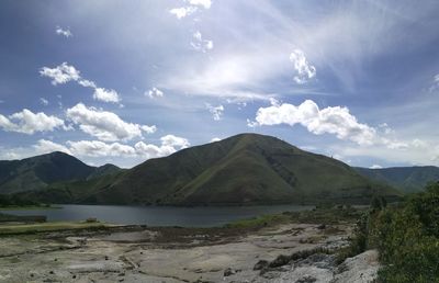 Scenic view of lake and mountains against sky