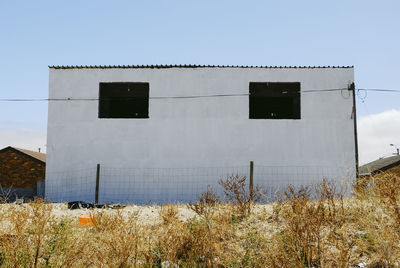 Low angle view of abandoned building against clear sky