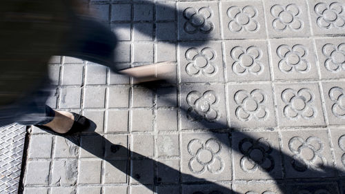 Low section of person walking on wall