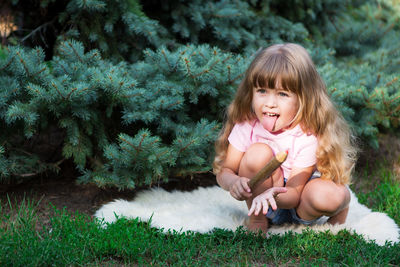 Happy girl sitting by plants