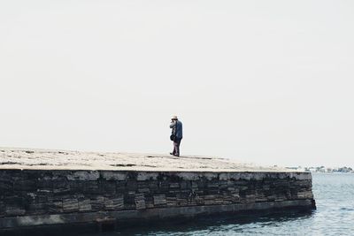 Full length of woman standing against clear sky