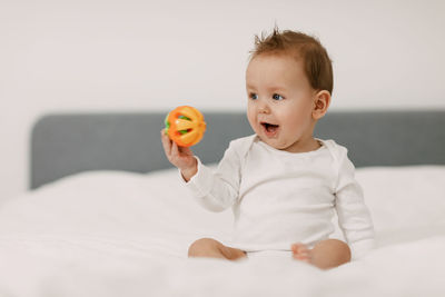 Cute boy sitting on bed