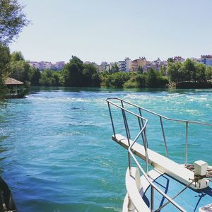 Boats in river with buildings in background