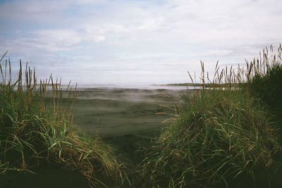 Scenic view of sea against cloudy sky