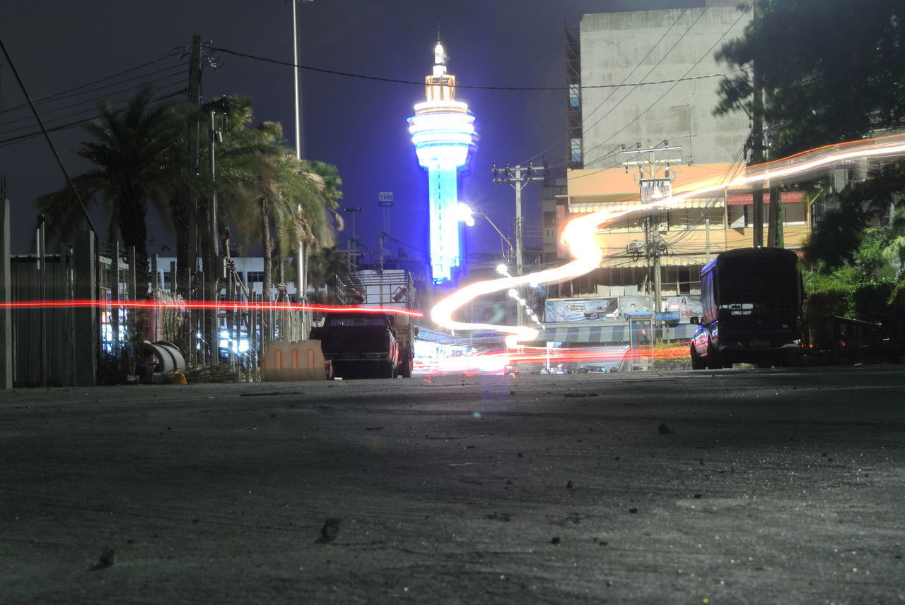 LIGHT TRAILS ON ROAD IN CITY