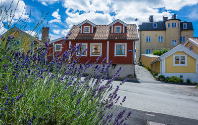 Street amidst houses and buildings against sky