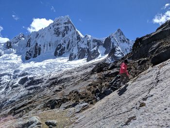 Girl walking on mountain against sky