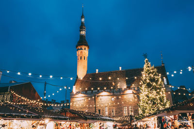 Low angle view of illuminated church against sky at night during christmas