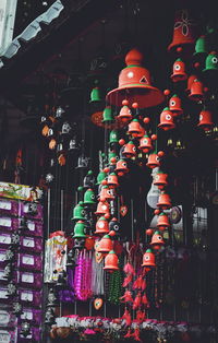 Illuminated lanterns hanging in store for sale