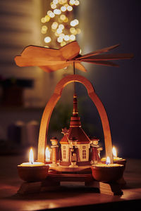 Close-up of illuminated candles on table
